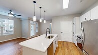 This contemporary 720 square foot apartment in Fishers, IN, offers a thoughtful blend of style and functionality. The open-concept design seamlessly integrates the kitchen and living room, creating a spacious feel. Rich hardwood floors run throughout, adding warmth and elegance to the space.

The kitchen is a highlight, boasting sleek white cabinetry, stainless steel appliances, and a convenient island with pendant lighting. The living area is bathed in natural light from large windows, and a modern ceiling fan ensures comfort.

The 140 square foot bedroom is generously sized, featuring a large window and ample closet space. The bathroom is well-appointed with modern fixtures and a clean, white aesthetic. A separate closet area provides additional storage options.

Throughout the apartment, neutral wall colors create a calm ambiance and serve as a blank canvas for personalization. Recessed lighting and strategically placed electrical outlets add to the overall functionality of the space.

This efficient single-floor layout maximizes every square foot, offering a perfect balance of comfort and style for modern living. The apartment's thoughtful design and quality finishes make it an attractive option for those seeking a contemporary urban lifestyle.