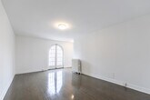 Located at 340 Avenue Rd in Toronto's sought-after Avenue Road corridor, this one-bedroom unit offers a thoughtfully organized layout across a single floor. The living room is a standout space, featuring gleaming hardwood floors, crisp white walls, and a striking pair of arched French doors that flood the room with natural light and lend a touch of classic architectural elegance. A cast iron radiator adds to the vintage character found throughout the unit.

The bedroom is a comfortable, well-proportioned retreat with hardwood flooring, a large window overlooking the surrounding neighbourhood, and its own cast iron radiator. Two separate doorways lead to a dedicated closet and an additional storage area, providing ample organization options.

The kitchen is clean and functional, outfitted with white cabinetry, subway tile backsplash, a dark countertop, a built-in electric cooktop, and a window that brings in natural light. A cast iron radiator is neatly tucked beneath the window, continuing the consistent heritage detailing found throughout the space.

The unit is completed by a hallway that connects all rooms efficiently. Consistent hardwood flooring, a bright white palette, and classic radiator heating throughout give this space a cohesive, timeless character well-suited to its established Toronto neighbourhood.