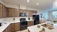 Located at 2635 Nez Perce Drive in Lewiston, Idaho, this thoughtfully designed one-bedroom, one-bathroom residence offers a comfortable and functional single-floor layout. The open-concept living, dining, and kitchen area creates a seamless flow throughout the main living space, anchored by light hardwood-style flooring and neutral walls that lend a clean, modern aesthetic.

The kitchen is a standout feature, boasting rich dark walnut-toned cabinetry with sleek hardware, white quartz countertops, and a large center island with an undermount sink and pendant lighting overhead. Black appliances, including a range, over-the-range microwave, and refrigerator, complement the warm cabinetry tones. Ample upper and lower cabinet storage makes the kitchen as practical as it is attractive.

The living room is bright and welcoming, with a large window offering outdoor views and allowing natural light to fill the space. The bedroom is a comfortable retreat, featuring carpet flooring, a ceiling fan, and a generous window with exterior views. Two closets provide excellent storage throughout the unit. The bathroom is clean and simply finished, with a tub-shower combination and light wood-style flooring. An in-unit laundry area adds everyday convenience to this well-appointed residence.