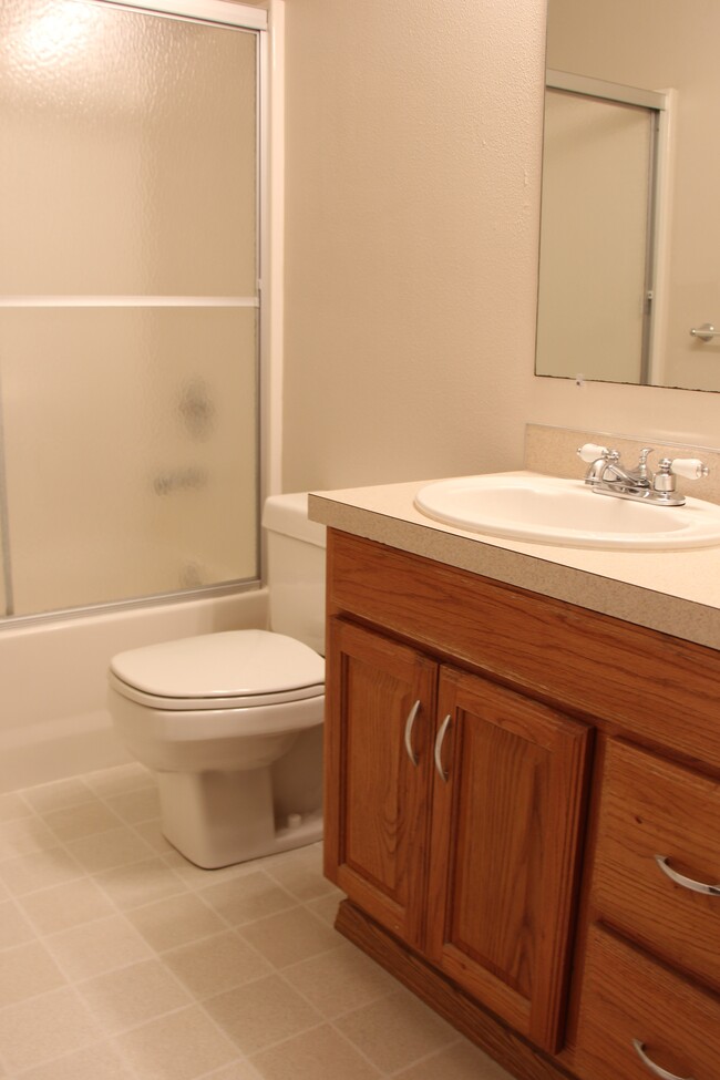 Bathroom comes with a glass shower door and white fixtures - 1211 Dumas Road