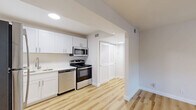 Located at 2000 24th Ave S in Nashville, TN, this single-floor, one-bedroom unit offers a well-organized layout that makes efficient use of its cozy footprint. The open-plan kitchen and living area serves as the heart of the home, featuring warm-toned hardwood flooring throughout. The kitchen is outfitted with crisp white shaker-style cabinetry, light countertops, a stainless steel sink, and a full suite of stainless steel appliances including a refrigerator, range, microwave, and dishwasher. Recessed lighting keeps the space bright and functional. The living area flows naturally from the kitchen, offering a clean, versatile space enhanced by the same hardwood flooring. The bedroom provides a comfortable retreat, finished with plush wall-to-wall carpeting for added warmth. A ceiling fan with a light fixture adds both comfort and ambiance, while a large sliding-door closet offers ample storage. A window invites natural light and views of surrounding greenery. The unit's neutral color palette of soft whites and warm beiges throughout creates a clean, welcoming atmosphere well-suited for everyday living in the heart of Nashville.