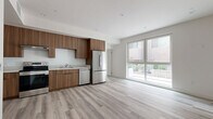 Located at 13716 Victory Blvd in Van Nuys, Los Angeles, this modern single-story unit offers a thoughtfully designed layout across a compact yet efficient floor plan. Light wood-look flooring runs seamlessly throughout, complementing the clean white walls and recessed lighting that give the space a bright, contemporary feel.

The open-concept kitchen and living area form the heart of the unit. The kitchen is outfitted with rich walnut-toned flat-panel cabinetry extending to the ceiling for ample storage, light-toned countertops, and a full suite of stainless steel appliances including a range, dishwasher, and refrigerator. A large sliding glass window-wall at the end of the living area floods the space with natural light and provides views of the surrounding exterior.

The generously sized bedroom is bright and airy, featuring a large window with outdoor views and a full-width mirrored sliding closet that enhances the sense of space. The clean, neutral palette throughout the room creates a calm and functional environment.

Additional features include a dedicated closet for storage and a well-placed entry area. The unit's modern design, quality finishes, and efficient use of space make it a practical and stylish home in the heart of the San Fernando Valley.
