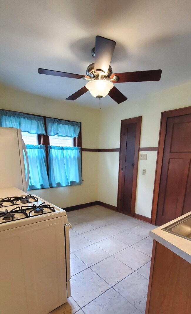 Kitchen with fresh paint, newer stove and refrigerator. - 1755 S 71st St