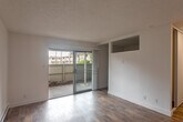 Located at 137 Felix St in Santa Cruz, California, this 2-bedroom, 1-bathroom unit offers a practical and well-organized single-floor layout. Throughout the space, wood-style flooring provides a warm, cohesive look, complemented by crisp white walls and textured ceilings. The open living area is bright and welcoming, highlighted by a sliding glass door that opens to an outdoor patio, allowing natural light to fill the room. A baseboard heater ensures year-round comfort. The kitchen is neatly arranged in a galley configuration, featuring white shaker cabinetry, gray quartz-style countertops, stainless steel appliances including a refrigerator and range, and a single-basin sink with a modern faucet. Overhead lighting keeps the space bright and functional. The primary bedroom is a comfortable size and includes a sliding-door closet with built-in wire shelving. The second bedroom features a window with outdoor views, adding natural light to the room. The shared bathroom includes a white vanity with gray countertop, a large mirror, and a shower/tub combination. Clean finishes and an efficient use of space make this unit a practical choice in the heart of Santa Cruz.