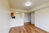 Located at 1585 Kipling St in Lakewood, Colorado, this 2-bedroom, 1-bathroom single-floor residence offers a practical and well-organized layout. Wood-look plank flooring runs throughout the entire space, providing a cohesive and easy-to-maintain finish across every room.

The kitchen is a functional highlight, featuring warm oak cabinetry with ample upper and lower storage, white appliances including an electric range and dishwasher, a stainless steel sink, and light countertops. A peninsula-style counter separates the kitchen from the living area, creating an open flow between the two spaces. The living room receives natural light through a glass sliding door that leads to a private balcony, with an additional window enhancing brightness. A wall-mounted HVAC unit provides in-unit climate control.

Both bedrooms are well-proportioned and finished with the same wood-look flooring and neutral cream walls. The primary bedroom includes a sliding double-door closet and a window with outdoor views, while the second bedroom also features a window and wall-mounted climate control. The bathroom includes a vanity with wood cabinetry, a toilet, and a towel bar, with consistent flooring tying the space together. The overall ambiance is clean, neutral, and move-in ready.
