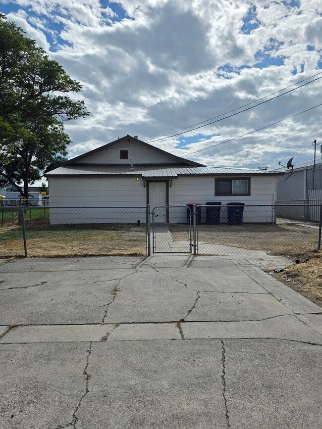 Back of house with parking and fenced yard - 552 5th Ave W