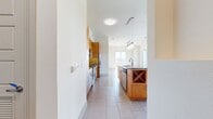 This contemporary apartment in Fiori On Vitruvian Park offers 1170 square feet of thoughtfully designed living space. The unit features two bedrooms, including a spacious 180 square foot primary bedroom, and two full bathrooms. The open-concept layout seamlessly integrates the kitchen and living areas, creating an ideal space for both relaxation and entertaining.

The gourmet kitchen is a highlight, boasting wooden cabinetry, granite countertops, and stainless steel appliances. A central island provides additional workspace and casual seating. Large windows throughout the apartment flood the rooms with natural light and offer picturesque views of the surrounding landscape.

Both bathrooms feature modern fixtures, including granite vanity tops and ample storage. The master bathroom includes a bathtub-shower combination and a spacious vanity. Generous closet space in both bedrooms ensures plenty of storage options.

The apartment's design emphasizes clean lines and neutral tones, creating a blank canvas for personal style. Plush carpeting in the bedrooms adds comfort, while sleek tile flooring in the kitchen and bathrooms contributes to the modern aesthetic. The unit also includes in-unit laundry facilities for added convenience.
