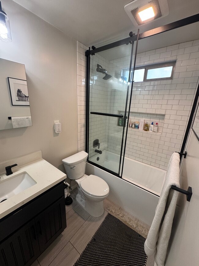 Remodeled bathroom with shower head water filter - 630 E San Antonio Dr
