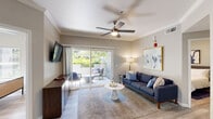 Located at 40 Park City Ct in Sacramento, CA, this single-story, 2-bedroom, 1-bathroom residence offers a thoughtfully designed layout with modern finishes throughout. Light wood-tone flooring flows seamlessly across the entire home, complemented by neutral walls that create a bright, cohesive atmosphere.

The living room is an inviting, well-proportioned space featuring crown molding, a ceiling fan, and sliding glass doors that open directly onto a private balcony. The balcony showcases a charming stucco archway and is framed by mature trees and lush greenery, offering a tranquil outdoor retreat.

The kitchen is efficiently laid out with white cabinetry, dark quartz countertops, stainless steel appliances, and a skylight that fills the space with natural light. An adjacent dining area provides a comfortable setting for meals. The combined living, dining, and kitchen area flows naturally together, ideal for everyday living and entertaining.

Both bedrooms are comfortably sized, each featuring ceiling fans, windows with garden views, and a calm, neutral palette. The primary bedroom includes a spacious walk-in closet with wire shelving systems for organized storage. The full bathroom is well-equipped with a dual-sink vanity, dark countertops, white cabinetry, and a tub-shower combination. A dedicated laundry area and hallway round out this functional and comfortable home.