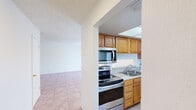 This 860 square foot apartment, located in Summit West, offers a well-designed living space with two bedrooms and one bathroom. The interior is characterized by its warm wood flooring, which runs throughout the main living areas and bedrooms, creating a cohesive and inviting atmosphere. The primary bedroom, measuring 160 square feet, provides a comfortable retreat.

The kitchen features oak cabinetry, stainless steel appliances, and a practical layout with ample counter space. It includes a dishwasher and a full-size refrigerator, catering to daily cooking needs. The bathroom is fitted with white tiling and essential fixtures, maintaining a clean and functional design.

Large windows in the bedrooms and living areas allow for plenty of natural light, enhancing the sense of space. The apartment includes a hallway for easy navigation between rooms and a closet for additional storage. The overall design prioritizes functionality and comfort, making efficient use of the available square footage.

The property's single-floor layout and modest size make it an ideal choice for small families, young professionals, or those seeking a low-maintenance urban living space. Its neutral color palette and simple design elements provide a blank canvas for personalization, allowing residents to easily adapt the space to their individual tastes and needs.