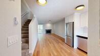 Located at 475 E North Bend Way in North Bend, Washington, this two-story, 2-bedroom, 2-bathroom home offers a thoughtfully laid-out living space spread across two floors. The main level features an open-concept kitchen and living area with warm hardwood flooring throughout. The kitchen is well-appointed with white shaker-style cabinetry, light countertops, and a full suite of stainless steel appliances including a refrigerator, range, microwave, and dishwasher. A window at the end of the kitchen brings in natural light and neighborhood views. The living room is anchored by a fireplace and receives ample natural light through a large window, creating a bright and welcoming atmosphere. A carpeted staircase leads to the upper level, which houses both bedrooms and a hallway. The primary bedroom offers a comfortable footprint with hardwood floors and generous natural light. The secondary bedroom also features hardwood flooring, a closet with sliding doors, and a window with a pleasant tree-lined view. Both bathrooms are clean and functional — one features a tub/shower combo with brushed nickel fixtures, while the other is a compact, well-finished space. The home's consistent use of hardwood flooring, neutral tones, and modern fixtures gives it a cohesive, move-in-ready feel.