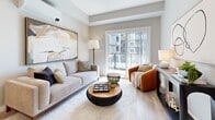 Located at 2840–2850 Carlow Road in Victoria, BC, this well-appointed one-bedroom, one-bathroom unit offers a thoughtfully designed layout across a single floor. Light wood-look flooring flows throughout, lending warmth and continuity to the space.

The kitchen is a standout feature, showcasing a two-tone design with crisp white upper cabinetry and rich wood-toned lower cabinets, complemented by a light quartz countertop, tile backsplash, and a full suite of stainless steel appliances including a French door refrigerator, built-in microwave, and gas range. A peninsula provides additional counter space and casual seating.

The living room is bright and inviting, with a sliding glass door opening to a balcony and views of the surrounding building complex. A wall-mounted mini-split unit provides climate control, while large windows fill the room with natural light.

The bedroom is a calm retreat finished in soft grey tones, featuring a generously sized window and direct access to a dedicated closet with built-in shelving and hanging rails. The full bathroom includes a wood-cabinet vanity with quartz countertop and a soaker tub-shower combination. A separate laundry room with side-by-side washer and dryer and built-in shelving adds practical convenience to this polished unit.