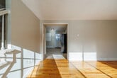 This two-story townhouse at 125 Spring Ave in Watertown, NY offers a practical and well-organized layout across two equally sized floors. The main level greets you with warm hardwood flooring throughout the living room and entryway, complemented by natural light streaming through multiple windows. A staircase with white balusters connects to the upper level, adding a clean, classic touch to the interior. The kitchen is efficiently designed with white cabinetry, light granite-style countertops, a stainless electric range, and tile flooring, with a door providing direct exterior access. The upper floor houses all three bedrooms, each finished with neutral carpet and featuring closets with built-in rods for ample storage. The spacious primary bedroom includes two closets and benefits from natural light through a large window. The full bathroom is bright and functional, offering a tub/shower combination, a white vanity, tile flooring, and a window overlooking the outdoors. A utility room and two hallways complete the floorplan. Baseboard heating is present throughout, and textured ceilings add a consistent finish across the home. The overall ambiance is clean, neutral, and move-in ready.