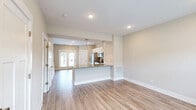 Located at 2744 Old Fort Pkwy in Murfreesboro, TN, this two-story home offers a thoughtfully designed layout spread across two floors. The main level features an open-concept kitchen and living area finished with light hardwood-style flooring throughout. The kitchen is well-appointed with white shaker cabinetry, granite countertops, a classic subway tile backsplash, stainless steel appliances including a French door refrigerator, electric range, over-the-range microwave, and dishwasher, all illuminated by recessed lighting and pendant fixtures. The living area flows naturally from the kitchen, bathed in natural light from large windows with blinds. A convenient half or full bathroom is also found on the main level. Upstairs, the two bedrooms feature plush carpeting, ceiling fans, and generous windows that bring in ample natural light with neighborhood views. The spacious primary bedroom includes its own dedicated closet. The upper level is served by well-finished bathrooms, one of which features a granite-topped white vanity and a soaking tub/shower combination with wood-look tile flooring. The home's neutral color palette, clean white trim, and consistent modern finishes create a bright, welcoming ambiance throughout.