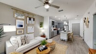 Located in Orlando, FL, this thoughtfully designed one-bedroom, one-bathroom residence offers a comfortable and functional layout across a single floor. The open-concept kitchen is a standout feature, showcasing gray shaker cabinetry, granite countertops, a herringbone tile backsplash, stainless steel appliances, and a central island with seating — ideal for both cooking and casual dining. Pendant lighting adds a polished finishing touch overhead. Wood-look flooring flows throughout the main living areas, creating a cohesive and contemporary aesthetic. The living room is bright and welcoming, featuring large windows that invite ample natural light, a ceiling fan, and direct access to a private balcony. The bedroom is a tranquil retreat with a soft accent wall, generous windows with outdoor views, and two closets for ample storage. The full bathroom features large-format marble-style tile flooring, a granite-topped vanity with gray cabinetry, and a full soaking tub with shower. A dedicated in-unit laundry area with a full-size washer and dryer adds everyday convenience. The overall ambiance is modern and airy, with a neutral color palette that lends itself to a calm, move-in-ready environment.