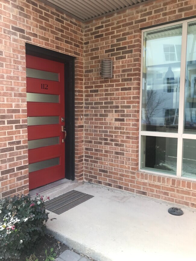 One of two exterior doors to the ground floor unit. Anti-theft bicycle anchor installed under covered front porch. - 1324 May Street