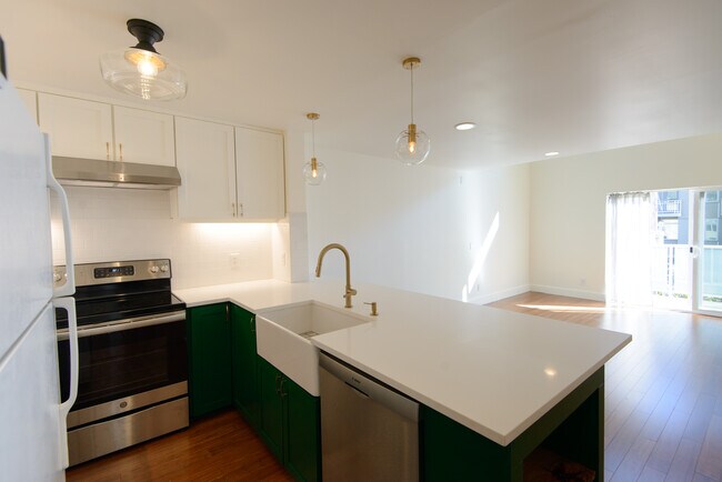 A completely renovated kitchen including all-new backsplash, quartz counters, and apron front-sink - 2250 NW 58th St