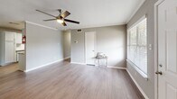 Located at 11111 W Montgomery Rd in Houston, TX, this 2-bedroom, 1-bathroom home offers a functional and well-appointed single-floor layout. The open-concept living, dining, and kitchen area serves as the heart of the home, featuring warm hardwood-style flooring, crown molding, and a ceiling fan that adds both comfort and style. Natural light filters in through window blinds, creating a bright and welcoming atmosphere.

The kitchen is efficiently designed with white shaker-style cabinetry, granite-look countertops, a subway tile backsplash, a double-basin stainless steel sink, and stainless steel appliances including a refrigerator, electric range, and dishwasher — providing ample storage and prep space.

Both bedrooms are carpeted and equipped with ceiling fans, offering a cozy retreat. Each room includes closet access, and the home features a total of four closets, ensuring generous storage throughout. The full bathroom includes a tub-shower combination with a tiled surround, a vanity with updated countertops, and hardwood-style flooring.

Additional highlights include a hallway connecting the main living areas, a dedicated laundry space, and a private balcony ideal for outdoor relaxation. The neutral gray color palette throughout lends the home a clean, modern aesthetic.