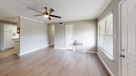 Located at 11111 W Montgomery Rd in Houston, TX, this 2-bedroom, 1-bathroom home offers a functional and well-appointed single-floor layout. The open-concept living, dining, and kitchen area serves as the heart of the home, featuring warm hardwood-style flooring, crown molding, and a ceiling fan that adds both comfort and style. Natural light filters in through window blinds, creating a bright and welcoming atmosphere.

The kitchen is efficiently designed with white shaker-style cabinetry, granite-look countertops, a subway tile backsplash, a double-basin stainless steel sink, and stainless steel appliances including a refrigerator, electric range, and dishwasher — providing ample storage and prep space.

Both bedrooms are carpeted and equipped with ceiling fans, offering a cozy retreat. Each room includes closet access, and the home features a total of four closets, ensuring generous storage throughout. The full bathroom includes a tub-shower combination with a tiled surround, a vanity with updated countertops, and hardwood-style flooring.

Additional highlights include a hallway connecting the main living areas, a dedicated laundry space, and a private balcony ideal for outdoor relaxation. The neutral gray color palette throughout lends the home a clean, modern aesthetic.