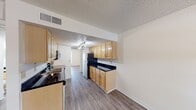 This 460 square foot apartment in Cambridge Woods offers a thoughtful single-floor layout, maximizing space efficiency. The standout feature is the generously sized 230 square foot bedroom, which provides ample living space. The room is illuminated by natural light from a large window and features a modern ceiling fan for comfort.

Throughout the apartment, recently updated wood-look flooring adds a contemporary touch and unifies the space. The kitchen, while compact, is well-equipped with light wood cabinetry, contrasting dark countertops, and full-sized appliances. Track lighting ensures good visibility for meal preparation.

The bathroom, though not expansive, includes essential fixtures and some storage space. A closet area near the bathroom offers additional storage solutions. The apartment's neutral color palette, primarily in shades of white and beige, creates a bright and airy atmosphere, making the space feel larger than its actual square footage.

Ceiling fans in both the main living area and bedroom provide air circulation and add to the overall comfort of the home. The layout is designed for easy flow between spaces, making this compact apartment feel open and inviting.