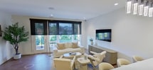 This contemporary 810 square foot apartment in Richmond Heights, OH, showcases a thoughtful design that maximizes space and functionality. The open-concept layout creates a seamless flow between the living areas, enhancing the sense of spaciousness. The living room is bathed in natural light from large windows, complemented by motorized shades for privacy control. A sleek kitchen boasts white cabinetry, stainless steel appliances, and a subway tile backsplash, perfect for culinary enthusiasts.

The bedroom, measuring 180 square feet, offers a serene retreat with plush carpeting and a well-appointed walk-in closet. The apartment features three bathrooms, each designed with modern fixtures and finishes. Neutral tones throughout provide a canvas for personalization, while recessed lighting adds to the ambiance.

High-end touches include a wall-mounted TV in the living area, stylish pendant lighting, and a private balcony accessible through glass doors. The property's attention to detail extends to practical elements like ample storage solutions and energy-efficient appliances, making this apartment an ideal blend of style and functionality for contemporary urban living.