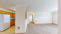 Located at 3045 Gehlar Rd NW in Salem, Oregon, this two-bedroom, two-bathroom unit offers a well-organized single-floor layout designed for comfortable everyday living. The open kitchen and living area form the heart of the home, with the kitchen featuring warm honey-toned wood cabinetry, tile flooring, and a full suite of white appliances including a refrigerator, range, microwave, and dishwasher. The adjacent living room is generously sized, finished with neutral carpet and clean white walls that create a bright, open feel. Both bedrooms are carpeted and filled with natural light from large windows fitted with blinds, offering pleasant outdoor views of surrounding greenery. The primary bedroom provides a comfortable amount of space and connects to its own bathroom. Both bathrooms include tile flooring, warm wood vanities with laminate countertops, large mirrors, and ample storage. One bathroom features a combination tub and shower enclosed with sliding glass doors, while the other offers an extended vanity with generous counter space. A dedicated closet adds practical storage. The unit's consistent use of neutral tones, carpet in living and sleeping areas, and tile in wet areas gives the space a cohesive and functional character throughout.