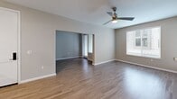 Located at 1113 Baywood Dr in Petaluma, California, this single-floor, one-bedroom, one-bathroom residence offers a thoughtfully designed layout with a clean, modern aesthetic throughout. Light wood-tone flooring runs across the main living areas, complemented by neutral gray walls and white trim that create a bright, cohesive look.

The open-concept living, dining, and kitchen area serves as the heart of the home. The kitchen is well-appointed with warm wood-grain cabinetry extending to the ceiling, stainless steel appliances including a gas range, microwave, and refrigerator, white quartz countertops, and a peninsula with pendant lighting that doubles as a breakfast bar. The living area features a ceiling fan and receives natural light through large windows and a glass exterior door.

A separate den provides flexible additional space, while two closets offer ample storage. The bedroom is carpeted for comfort and includes a window with natural light. The bathroom is finished with wood-grain cabinetry, a white countertop vanity, a framed mirror, and wood-look flooring. In-unit stacked laundry and a dedicated utility room add practical convenience. The overall design is modern and move-in ready.