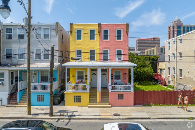 Colorful duplexes share covered front porches and small side yards in Chelsea.
