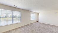 Located at 3814 Burberry Dr in Lafayette, Indiana, this single-floor, 2-bedroom, 2-bathroom home offers a practical and comfortable layout. The living area is finished with neutral-toned carpet and features multiple windows fitted with blinds, allowing natural light to fill the space. A textured ceiling adds subtle character throughout the main living areas. The kitchen is a functional highlight, showcasing rich dark-cherry cabinetry, dark granite-style countertops, hardwood-style flooring, and a full suite of black appliances including a refrigerator, dishwasher, electric range, and microwave. The primary bedroom is generously sized, featuring hardwood-style flooring, a ceiling fan with light fixture, and a sliding glass door that opens to an outdoor area, bringing in additional natural light. The second bedroom is carpeted with a textured ceiling and a window overlooking the outdoors. Both bathrooms are clean and functional, with one featuring a full tub-shower combo. The dedicated laundry room includes an in-unit washer and dryer, a built-in countertop workspace, wire shelving, and hardwood-style flooring—providing excellent utility. A dedicated closet completes the thoughtful layout of this well-appointed home.
