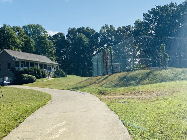 front of house with the tennis and basket ballcourt in front - 5328 Smiley Hollow Rd