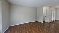 This 830 square foot apartment offers a practical and contemporary living space. The open-concept design seamlessly integrates the living room, dining area, and kitchen, creating a spacious feel. Rich hardwood floors run throughout the main living areas, adding warmth and sophistication.

The updated kitchen features crisp white cabinetry, granite countertops, and black appliances, providing both style and functionality. A balcony, accessible through French doors in the living area, offers outdoor space and natural light.

The primary bedroom, measuring 140 square feet, includes a closet and carpeted flooring for comfort. The second bedroom also features carpet and a window for natural light. Both full bathrooms are modernized with updated fixtures, including vanities with granite countertops and framed mirrors.

Throughout the apartment, neutral wall colors and recessed lighting contribute to a bright, airy ambiance. The thoughtful layout maximizes the use of space, making this compact apartment feel larger than its actual square footage. With its blend of modern amenities and efficient design, this apartment offers comfortable urban living.