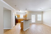 Located at 301 Lakeshore Blvd N in Slidell, Louisiana, this single-story, 3-bedroom, 2-bathroom home offers a well-designed layout with a comfortable, functional floor plan. Light-toned wood-look flooring runs throughout the main living areas, complemented by neutral walls and crown molding that lend a clean, cohesive aesthetic.

The heart of the home is an open-concept space combining the living room, dining area, and kitchen. The living room features a ceiling fan with light fixture and access to natural light through a glass door leading to the patio. The kitchen is outfitted with warm honey-toned wood cabinetry, ample counter space, a U-shaped layout, black appliances, and a breakfast bar peninsula that opens to the living and dining areas, making it ideal for both everyday living and entertaining. A pantry provides additional storage convenience.

The three bedrooms offer plush carpeting and ceiling fans, with the secondary bedrooms featuring closets and natural light from windowed walls. The primary bedroom is a comfortable size with its own closet access. Both bathrooms include wood-toned vanity cabinetry and tiled shower/tub combinations. A dedicated laundry room and multiple hallway closets add practical storage throughout. The home is completed by a welcoming entrance and an outdoor patio space.