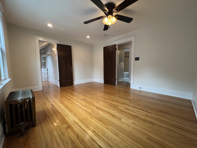 Large master bedroom with walk-in closet, ceiling fan and recessed lights. - 61 Hirschfield Dr