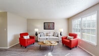 This single-floor residence at The Courtyard in New Albany, Indiana, offers a thoughtfully organized layout connecting living, dining, kitchen, and sleeping areas in a cohesive flow. The living room is generously proportioned, featuring wood-style flooring, a textured ceiling, and large windows that invite natural light throughout the day. The space comfortably accommodates a full seating arrangement, making it well-suited for both relaxing and entertaining.

Adjacent to the living room, the dedicated dining area continues the wood-style flooring and is equipped with a ceiling fan for added comfort. A window brings in additional natural light, creating a bright and pleasant atmosphere for meals.

The kitchen is well-equipped with white shaker-style cabinetry, light granite-look countertops, a double-basin stainless steel sink, and an electric range. Ample upper and lower cabinet storage ensures practical functionality throughout.

The bedrooms are carpeted for warmth and comfort, each featuring neutral tones and windows that allow for natural light. The rooms offer sufficient space for standard bedroom furnishings.

The bathroom includes a full tub-shower combination, a white vanity with storage, wood-style flooring, and a textured ceiling, maintaining the clean, consistent aesthetic found throughout the residence.