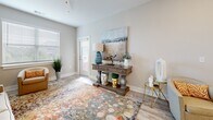 Located in Hickory, NC, this well-appointed 2-bedroom, 2-bathroom single-floor home offers a thoughtfully designed layout with modern finishes throughout. Light wood-look flooring flows seamlessly across the entire space, creating a cohesive and airy feel.

The kitchen is a standout feature, showcasing crisp white shaker cabinetry, granite countertops with an eat-in breakfast bar, and a full suite of stainless steel appliances, including a refrigerator, range, and microwave. It opens toward the living area, making it ideal for everyday living and entertaining.

The living room is bright and welcoming, with natural light filtering through large windows and direct access to an outdoor entry. The spacious primary bedroom includes a ceiling fan, generous natural light, and a barn-style sliding door leading to a well-appointed en-suite bathroom with granite vanity countertops and a tub-shower combination. The second bedroom is equally comfortable, featuring soft neutral tones and ample space.

Both bathrooms are finished with white cabinetry, granite counters, and clean, modern fixtures. A dedicated laundry room with side-by-side washer and dryer hookups adds everyday convenience. Throughout the home, neutral warm-gray walls and consistent flooring lend a cohesive, move-in-ready aesthetic.