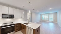 Located at 200 Middletown Blvd in Langhorne, PA, this well-appointed 3-bedroom, 2-bathroom residence offers a thoughtfully designed single-floor layout with modern finishes throughout. The open-concept kitchen and living area serves as the heart of the home, featuring two-tone cabinetry with rich walnut-toned lower cabinets and crisp white uppers, sleek quartz countertops, a stainless steel sink, stainless steel refrigerator, and stylish pendant lighting overhead. Light wood-style flooring flows through the main living area, lending warmth and continuity to the space. The living room benefits from natural light through a large window, creating a bright and welcoming atmosphere. The primary bedroom is a comfortable retreat, while the additional bedrooms offer plush carpeting, generous windows with natural light, and ample closet space, including a double-door closet. The primary bathroom showcases a dual-sink vanity with rich wood cabinetry, a wide illuminated mirror, and clean tile flooring, while the second bathroom features a tub-shower combination with marble-style tile surround. A dedicated in-unit laundry room with side-by-side washer and dryer and built-in shelving adds everyday convenience. The overall aesthetic is clean, contemporary, and move-in ready.