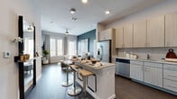 Located at 486 Centerpointe Circle in Altamonte Springs, FL, this single-floor, 2-bedroom, 2-bathroom residence offers a well-designed layout with modern finishes throughout. The open-concept kitchen is a standout feature, boasting light wood cabinetry, granite countertops, a full suite of stainless steel appliances, and a central island with bar seating — ideal for both meal prep and casual dining. Dark hardwood-style flooring flows seamlessly through the kitchen and into the living area, creating a cohesive, contemporary feel. The living room is bright and welcoming, featuring large windows with plantation shutters that invite natural light, a ceiling fan, and a bold slate-blue accent wall. Both bedrooms are comfortably sized, with the primary bedroom offering ample room and its own closet and en-suite bathroom access. The bathrooms are well-appointed with granite vanity countertops, gray cabinetry, and large-format tile flooring; one features a tub-shower combination. A hallway connects the private areas of the residence, which also includes two closets for generous storage. The overall ambiance is clean, contemporary, and thoughtfully finished, making this Altamonte Springs residence a refined and functional living space.