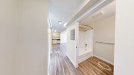 Located at 17763 15th Ave NE in Shoreline, Washington, this efficiently designed single-floor unit makes thoughtful use of its compact footprint. Wood-look plank flooring runs continuously throughout the space, lending a cohesive and clean aesthetic to every room.

The combined kitchen and living area serves as the heart of the unit. The kitchen is well-appointed with light maple cabinetry offering generous upper and lower storage, granite-look countertops, and a full suite of stainless steel appliances including a range, refrigerator, and dishwasher. A stainless steel sink with a modern faucet completes the functional layout. The adjoining living area is bright and open, benefiting from a large multi-pane window that fills the space with natural light and provides outward views of the surrounding neighborhood.

The bathroom is clean and straightforward, featuring a full soaking tub with an overhead shower, a single-sink vanity topped with granite-look counters and light wood cabinetry, and a towel bar. Neutral wall tones keep the space feeling fresh and airy. A dedicated closet provides additional storage. Recessed and flush-mount ceiling lighting ensures consistent illumination throughout. The overall design is functional, modern, and well-maintained, making efficient use of every square foot.
