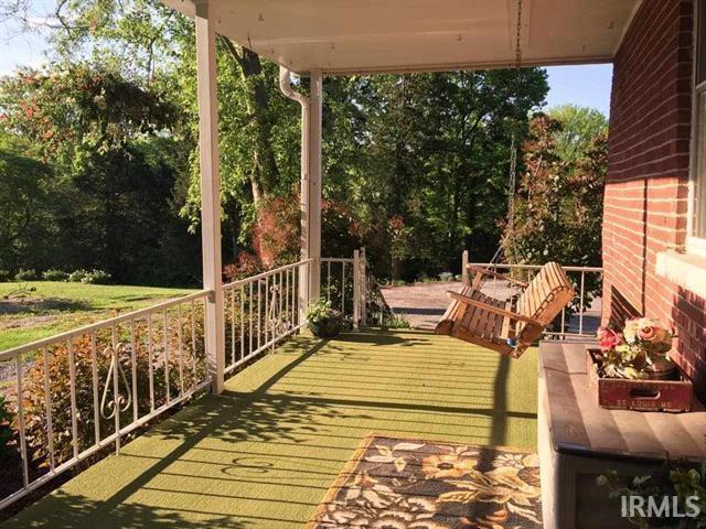 Covered porch with swing - 125 S State Road 446
