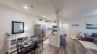 Located at 304 Hannah Todd Pl in Lexington, Kentucky, this single-story 2-bedroom, 2-bathroom home offers a thoughtfully designed layout with modern finishes throughout. The open-concept kitchen and living area serves as the heart of the home, featuring white shaker-style cabinetry, granite countertops, stainless steel appliances, and a central island with bar seating illuminated by pendant lighting. Light wood-tone flooring runs through the main living areas, complementing the neutral color palette and recessed lighting overhead. The adjacent living room is bright and welcoming, with a ceiling fan, large windows that invite natural light, and a comfortable, open feel. A dedicated dining area sits conveniently alongside the kitchen. Both bedrooms are carpeted and well-sized, offering a calm retreat. The primary bedroom includes access to a walk-in closet. Each bathroom features a shower-tub combination with clean, neutral finishes. A dedicated laundry room with overhead shelving and in-unit washer hookups adds everyday convenience. Two closets provide ample storage throughout. The home's efficient single-floor plan and cohesive design make for a functional and inviting living space in a residential Lexington neighborhood.