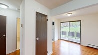 Located at 101 Bellgrove Drive in Mahwah, NJ, this one-bedroom, one-bathroom residence offers a thoughtfully arranged single-floor layout with a clean, functional design throughout. Rich hardwood flooring flows continuously through the living room, dining room, hallway, and bedroom, lending warmth and cohesion to the space. The living room is bright and open, featuring a large sliding glass door that leads to a private balcony with outdoor views of the surrounding greenery. A separate dining room connects naturally to the living area, creating a comfortable flow for everyday living and entertaining. The kitchen is equipped with a gas range, ample dark-wood cabinetry providing generous storage, light countertops, and tile flooring. The spacious primary bedroom features hardwood floors, a large window overlooking the tree-lined exterior, and a wall-unit air conditioner. The bathroom includes a full tub-shower combination with classic tile surround. Four closets distributed throughout the unit offer exceptional storage capacity. A welcoming hallway with a dark-wood interior door completes the layout, making this a well-appointed and practical residence in a green suburban setting.