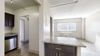 Located at 500 Rep. John Lewis Way North in downtown Nashville, TN, this three-bedroom, one-bathroom unit offers a compact yet well-organized single-floor layout. Wood-style flooring flows consistently throughout, lending a cohesive and modern aesthetic to every room.

The kitchen is a standout feature, equipped with dark espresso cabinetry, granite countertops, stainless steel appliances including a refrigerator, range, microwave, and dishwasher, and a single-basin sink with a sleek gooseneck faucet. A peninsula with matching granite extends into the living area, creating an open, connected feel.

The living area receives generous natural light through horizontal-blind-covered windows, with a ceiling fan providing added comfort. The spacious primary bedroom also includes a ceiling fan, a window unit for climate control, and access to a dedicated closet. The additional bedrooms are bright and versatile, each with wood-style floors and neutral walls.

The full bathroom features a tiled tub-shower combo, a granite-topped vanity with dark cabinetry, and wood-style flooring that mirrors the rest of the unit. Two closets provide practical storage solutions throughout. A central hallway connects all rooms efficiently, completing this functional and neatly appointed Nashville residence.