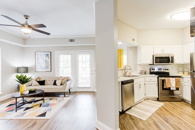 Living Room and Kitchen with Hardwood-Style Flooring - Walnut Hill Apartments