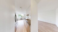 Located at 2175 Avenue Road in Toronto's desirable Avenue Road corridor, this 2-bedroom, 1-bathroom unit offers a clean, modern aesthetic throughout. Light hardwood-style flooring runs continuously across all rooms, complemented by crisp white walls that create a bright and airy atmosphere.

The open living room is a standout feature, bathed in natural light from two large windows that frame views of mature trees, with classic cast-iron radiators providing warmth. The galley-style kitchen is thoughtfully designed with white cabinetry, dark countertops, a white subway tile backsplash, and a full suite of stainless steel appliances including a refrigerator, electric range, and over-the-range microwave.

The primary bedroom is generously proportioned, featuring a closet and an additional door, offering functional flexibility. The second bedroom is bright and welcoming, with a large window overlooking lush greenery and a cast-iron radiator. Both bedrooms feature the same warm flooring found throughout the unit.

The bathroom is finished with floor-to-ceiling white subway tile, a soaker tub with a handheld showerhead, a window for natural light, and a clean white vanity. A hallway connects all rooms efficiently, completing this well-organized and move-in-ready unit.