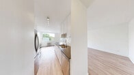 Located at 2175 Avenue Road in Toronto's desirable Avenue Road corridor, this 2-bedroom, 1-bathroom unit offers a clean, modern aesthetic throughout. Light hardwood-style flooring runs continuously across all rooms, complemented by crisp white walls that create a bright and airy atmosphere.

The open living room is a standout feature, bathed in natural light from two large windows that frame views of mature trees, with classic cast-iron radiators providing warmth. The galley-style kitchen is thoughtfully designed with white cabinetry, dark countertops, a white subway tile backsplash, and a full suite of stainless steel appliances including a refrigerator, electric range, and over-the-range microwave.

The primary bedroom is generously proportioned, featuring a closet and an additional door, offering functional flexibility. The second bedroom is bright and welcoming, with a large window overlooking lush greenery and a cast-iron radiator. Both bedrooms feature the same warm flooring found throughout the unit.

The bathroom is finished with floor-to-ceiling white subway tile, a soaker tub with a handheld showerhead, a window for natural light, and a clean white vanity. A hallway connects all rooms efficiently, completing this well-organized and move-in-ready unit.