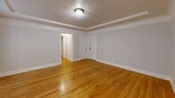 Located at 708 NW 19th Ave in Portland, Oregon, this one-bedroom, one-bathroom unit blends classic character with functional design throughout its well-organized single-floor layout. Warm hardwood floors flow through the living room, bedroom, and hallway, catching natural light from multiple windows and lending the space a bright, inviting atmosphere. The living room is generously proportioned, featuring a distinctive textured ceiling, clean crown molding, and a charming cast-iron radiator beneath large multi-pane windows that frame neighborhood views. The combined dining room and kitchen is efficiently laid out, offering abundant white cabinetry that extends floor to ceiling, dark countertops, subway tile backsplash, and full appliances — providing excellent storage and prep space. The bedroom is comfortably sized with its own window overlooking the surroundings, continuing the hardwood flooring and neutral palette found throughout. The bathroom features a full tub-shower combination, a windowed niche for natural light, and elegant herringbone-patterned tile flooring. Three closets distributed throughout the unit offer exceptional storage. The overall aesthetic is one of timeless character, clean lines, and practical livability in one of Portland's most walkable urban neighborhoods.