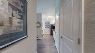 This single-story residence offers a thoughtfully designed layout that balances comfort and functionality throughout its well-defined living spaces. The kitchen serves as a central highlight, featuring white shaker cabinetry, granite countertops, stainless steel appliances including a refrigerator, range, and microwave, and a breakfast bar peninsula. Track lighting illuminates the galley-style workspace, which flows seamlessly into the adjacent dining area. The dining space accommodates a full-sized table and benefits from natural light through a window, complemented by a pendant light fixture overhead.

The living room is bright and welcoming, with wood-look flooring, multiple windows providing natural light and outdoor views, and ample space for comfortable seating arrangements. Both bedrooms are carpeted and feature windows with blinds and curtain panels, offering a quiet and restful atmosphere. The primary bedroom is generously proportioned with room for a full bedroom suite.

Two bathrooms serve the residence, each finished with granite-topped vanities, white cabinetry, tub-shower combinations with tile surrounds, and wood-look flooring. One bathroom also includes a walk-in closet accessible directly from the space. Neutral wall tones and consistent finishes throughout create a cohesive, modern aesthetic.