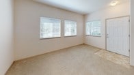 This single-floor residential unit offers a practical and well-organized layout designed for comfortable everyday living. The kitchen is outfitted with light wood cabinetry, a full suite of white appliances including a refrigerator, electric range, and dishwasher, and durable tile flooring in a neutral tone. The cabinetry provides ample storage, and the U-shaped configuration makes efficient use of the available space.

The living area is carpeted in a warm beige tone and connects openly to the kitchen, creating a cohesive common space. Natural light filters into the living room through multiple windows fitted with horizontal blinds, lending the area a bright and airy feel.

The bedroom is generously proportioned, featuring soft wall-to-wall carpeting and two separate closets with sliding doors, offering substantial storage capacity. A window with blinds allows natural light to enter while maintaining privacy.

The bathroom features tile flooring that mirrors the kitchen, along with a vanity with under-sink cabinetry, a toilet, and a full bathtub with a shower curtain rod. The clean, neutral finishes throughout the unit create a cohesive and understated aesthetic that is easy to personalize.