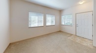 This single-floor residential unit offers a practical and well-organized layout designed for comfortable everyday living. The kitchen is outfitted with light wood cabinetry, a full suite of white appliances including a refrigerator, electric range, and dishwasher, and durable tile flooring in a neutral tone. The cabinetry provides ample storage, and the U-shaped configuration makes efficient use of the available space.

The living area is carpeted in a warm beige tone and connects openly to the kitchen, creating a cohesive common space. Natural light filters into the living room through multiple windows fitted with horizontal blinds, lending the area a bright and airy feel.

The bedroom is generously proportioned, featuring soft wall-to-wall carpeting and two separate closets with sliding doors, offering substantial storage capacity. A window with blinds allows natural light to enter while maintaining privacy.

The bathroom features tile flooring that mirrors the kitchen, along with a vanity with under-sink cabinetry, a toilet, and a full bathtub with a shower curtain rod. The clean, neutral finishes throughout the unit create a cohesive and understated aesthetic that is easy to personalize.