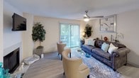 Located at 3400 Sweetwater Rd in Lawrenceville, Georgia, this single-floor residence offers a thoughtfully designed layout with a warm, neutral aesthetic throughout. The living room serves as the heart of the home, highlighted by a clean white-surround fireplace with a wall-mounted television above it, light wood-style flooring, and a ceiling fan. A sliding glass door floods the space with natural light and opens to an outdoor area, creating a seamless indoor-outdoor connection. The living area is further elevated by its open feel and comfortable seating arrangement.

The galley-style kitchen is efficiently organized, featuring gray cabinetry, light countertops, a double-basin sink, and stainless steel appliances including a refrigerator and electric range. The space is well-lit and offers ample storage for everyday living.

The bedroom provides a tranquil retreat, with plush carpeting, a built-in window bench seat with blinds that invite soft natural light, and a textured ceiling. The room comfortably accommodates a large bed and complementary furnishings, offering a serene and restful atmosphere.

Throughout the residence, warm neutral tones, consistent flooring, and carefully selected finishes contribute to a cohesive and inviting living environment.